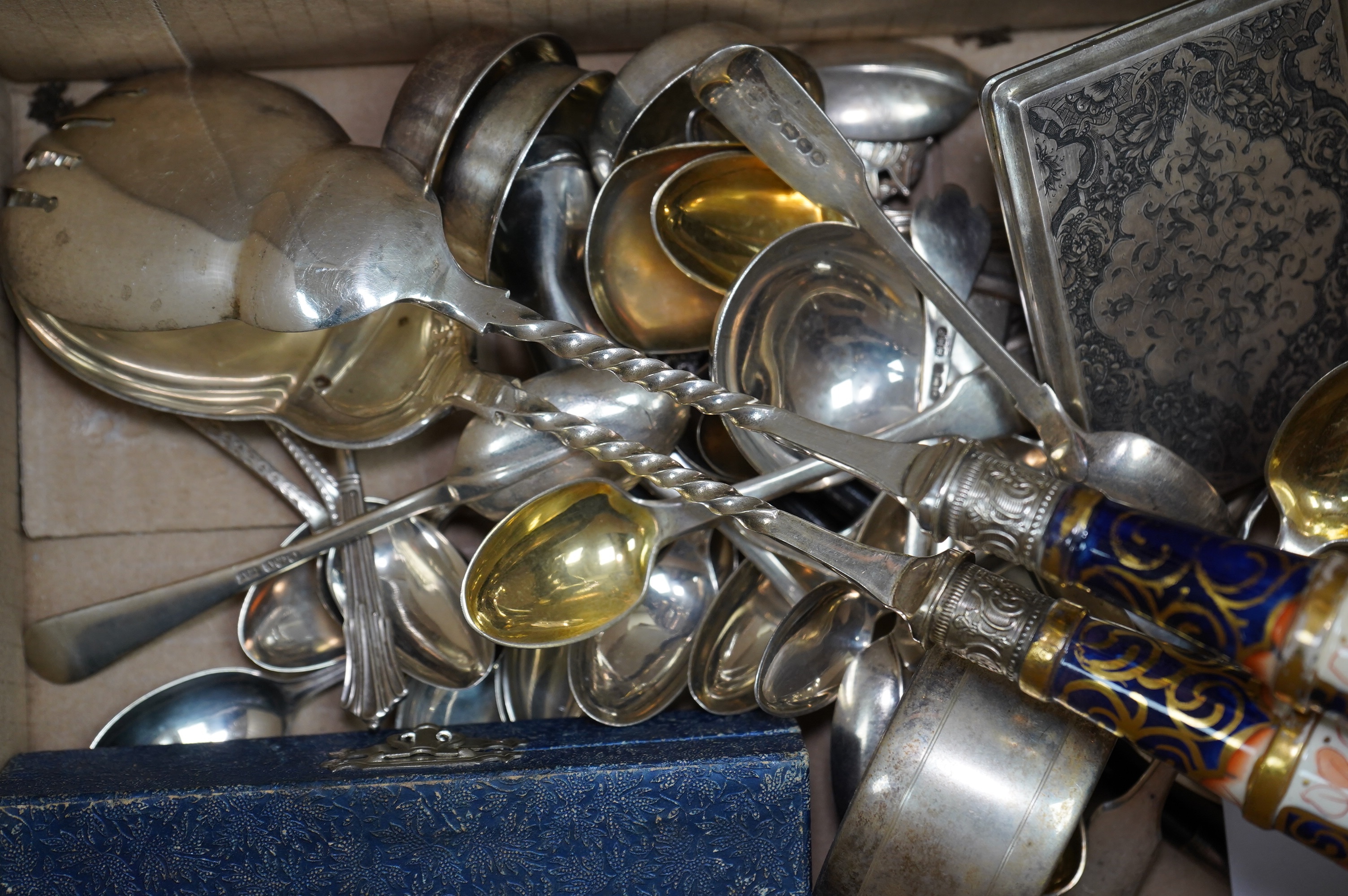 A small quantity of silver flatware, assorted plated cutlery, napkin rings and servers. Condition - varies, mostly fair